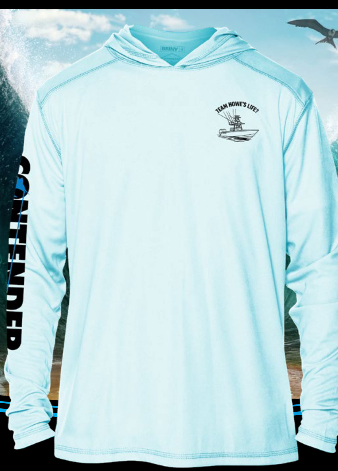Light blue hoodie with branding and text on a blurred natural background